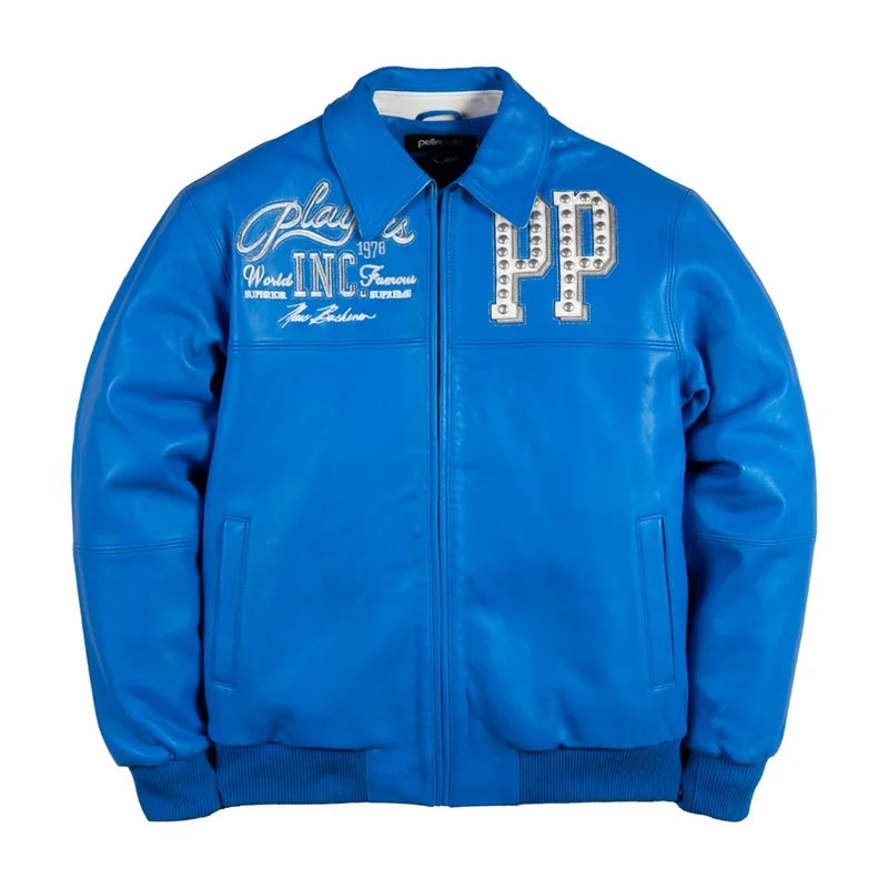 Royal blue leather-style streetwear jacket with silver embroidered graphics, studded chest detailing, full front zipper, ribbed cuffs, and classic collar on a white background.