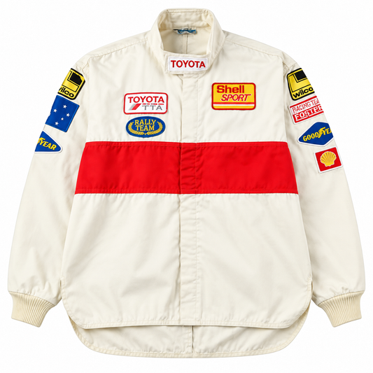 Front view of an off-white vintage racing jacket featuring a bold red stripe, colorful motorsport patches, and a classic retro design.